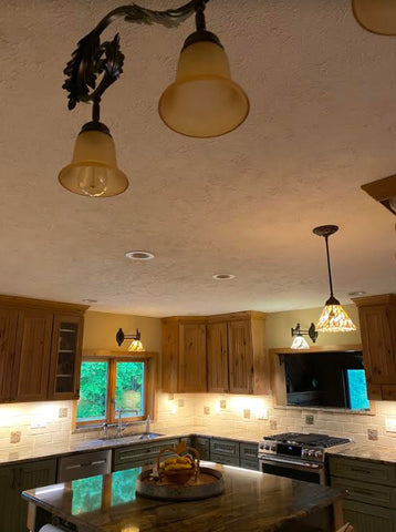 handmade maple leaf tiles installed in a kitchen backsplash