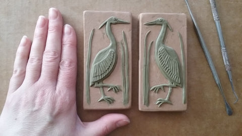 the process of making handmade tiles with a heron design 