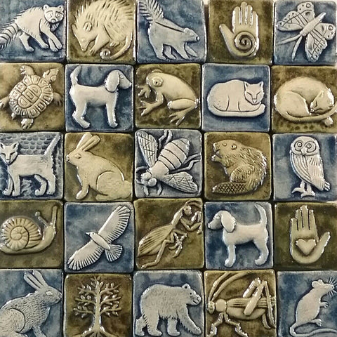 two inch by two inch handmade tiles featuring animals, blue and green glaze
