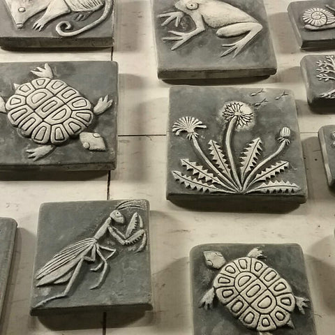 handmade tiles in the process of being glazed