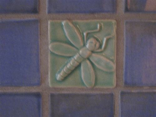 dragonfly art tile installed with handmade field tiles