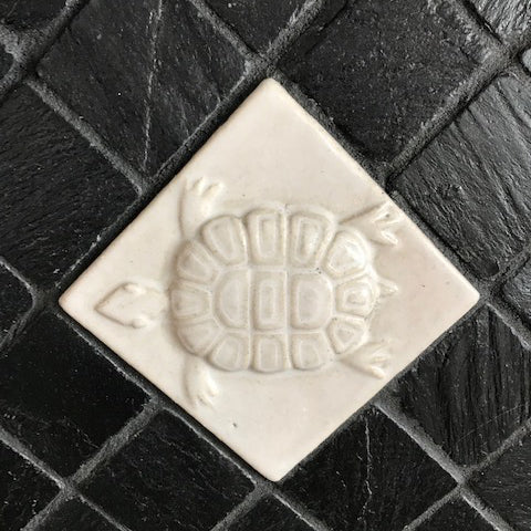 black and white back splash featuring handmade tiles and slate, turtle tile close up