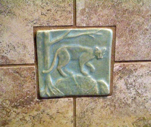 handmade mountain lion or cougar tile installed in shower