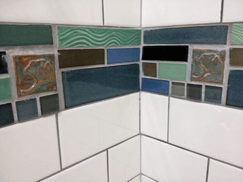 blue and green glass mosaic tiles with white subway tiles and art tiles