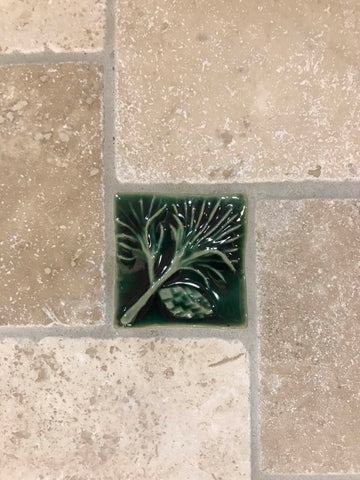 close up of a handmade pine tile installed in a kitchen backsplash