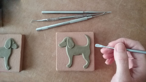 sculpting dog handmade tiles