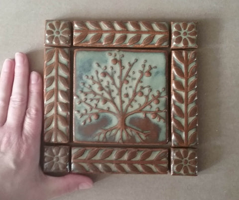 handmade tile set featuring a tree of life with a border