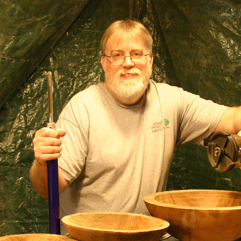 Kim Dailey at the lathe with some roughed out bowls - Dailey Woodworking