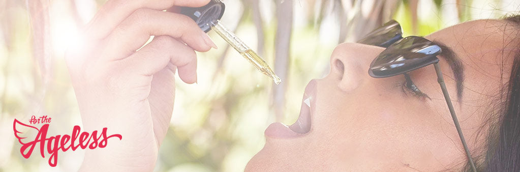 Woman dropping CBD under tongue