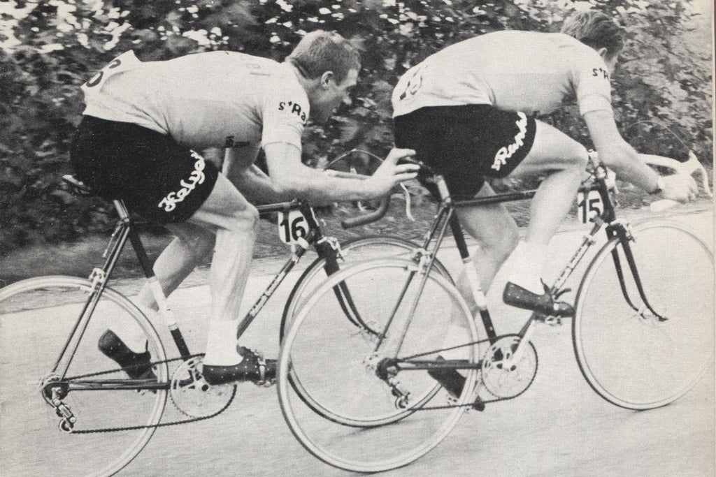 Rudi Altig gives Jacques Anquetil at helping hand at as they ride to victory at the 1962 Baracchi Trophy.