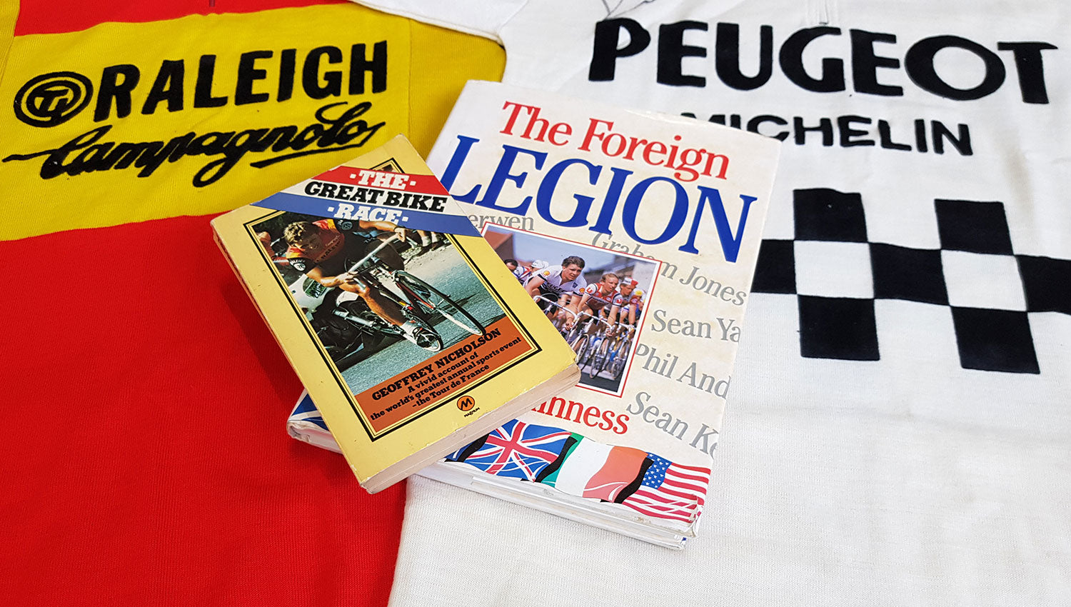 The Great Bike Race by Geoff Nicholson and The Foreign Legion by Rupert Guinness.  Both published a long time before cycling books were a popular line in your local bookshop.