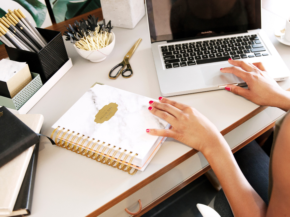 Stylish work desk with laptop and planner