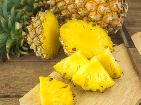 slices of pineapple on wooden cutting board