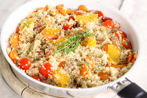 white bowl of quinoa and tomatoes