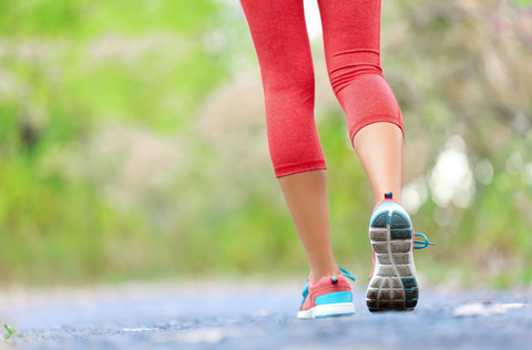 Woman with athletic legs on jog or run on trail