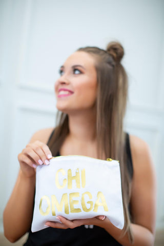 Girl holding Chi Omega cosmetic bag
