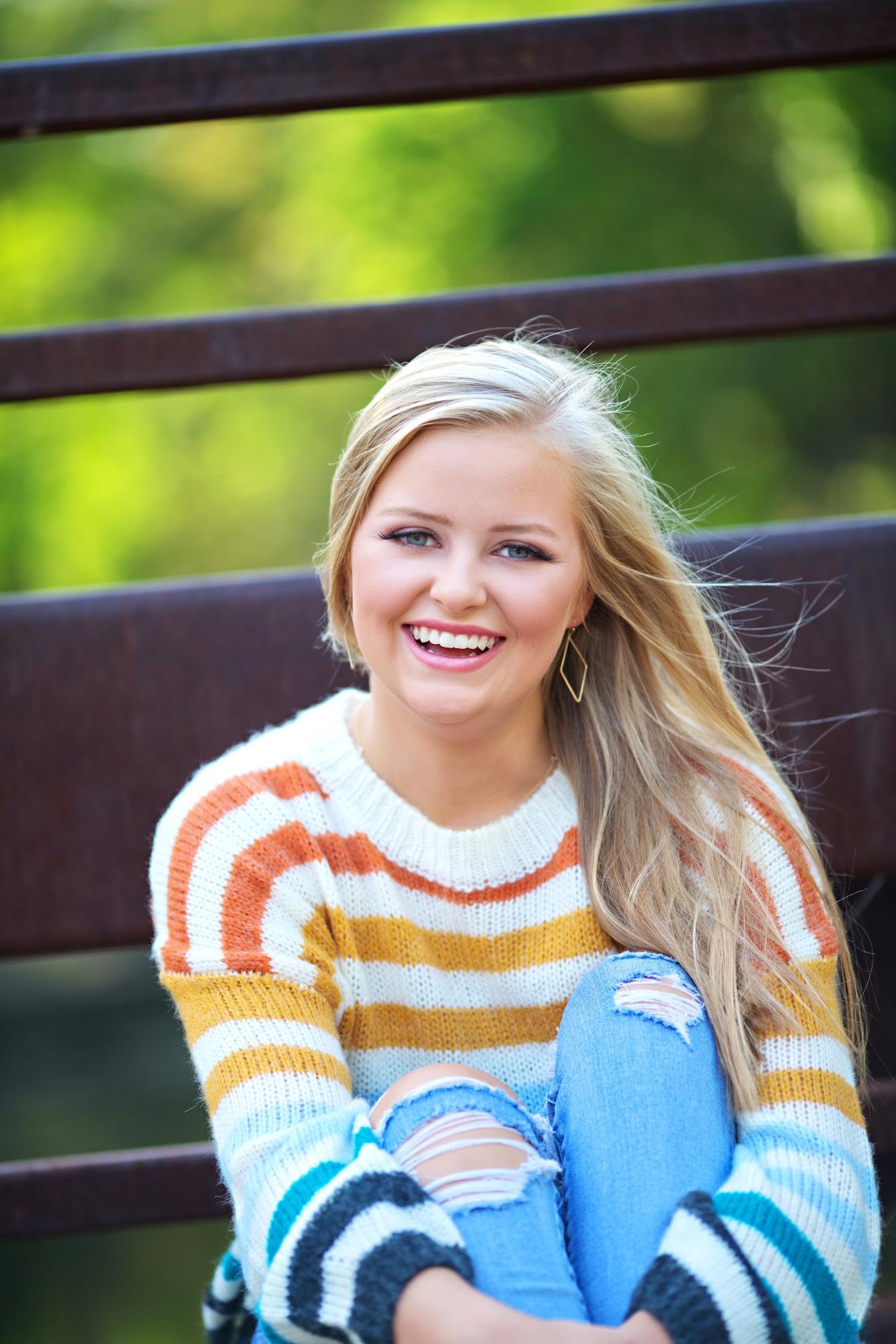 Portrait of girl smiling wearing a striped sweater