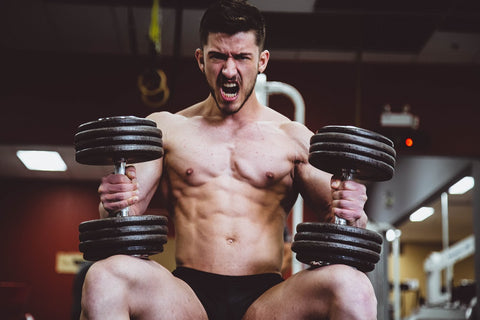 Man holding two heavy dumbbells for a chest workout