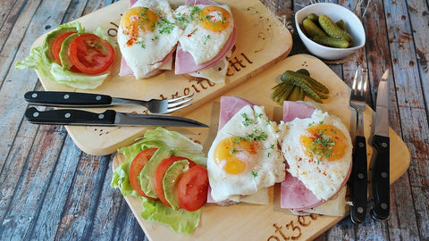Eggs and toast on small chopping boards