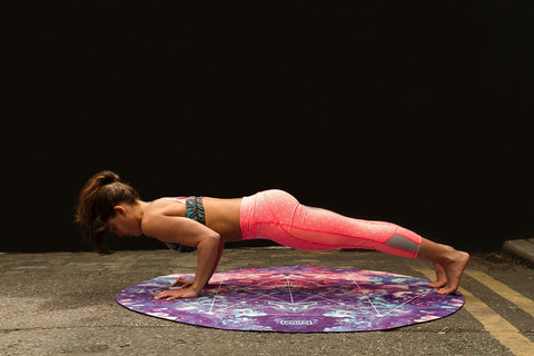 Woman on a yoga mat doing push ups
