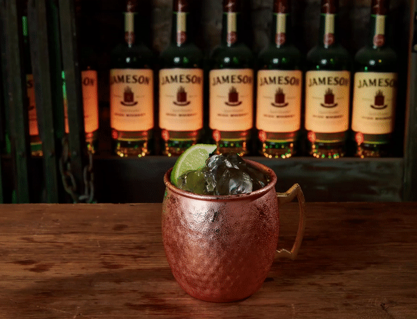 Moscow Muled copper mug containing liquid ice and lime spinning GIF