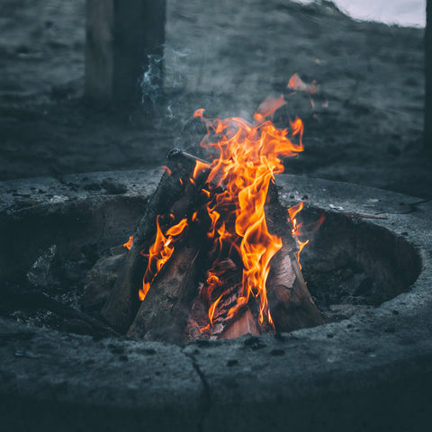 a fire pit burning logs