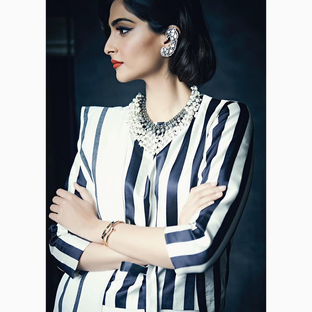 Sonam Kapoor attending the store launch at Mumbai Wearing a black and white striped long sleeved blouse from Raw Mango collection's saree in a Gujrati style drape