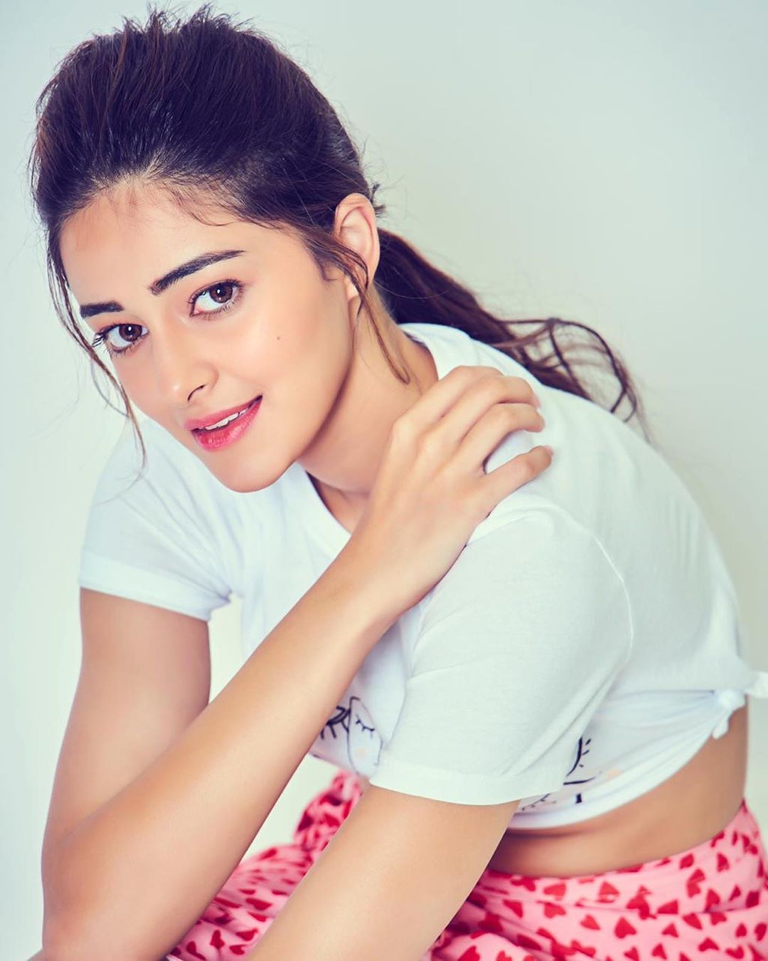 Ananya-Panday-in-pink-printed-skirt-teamup-with-white-crop-top