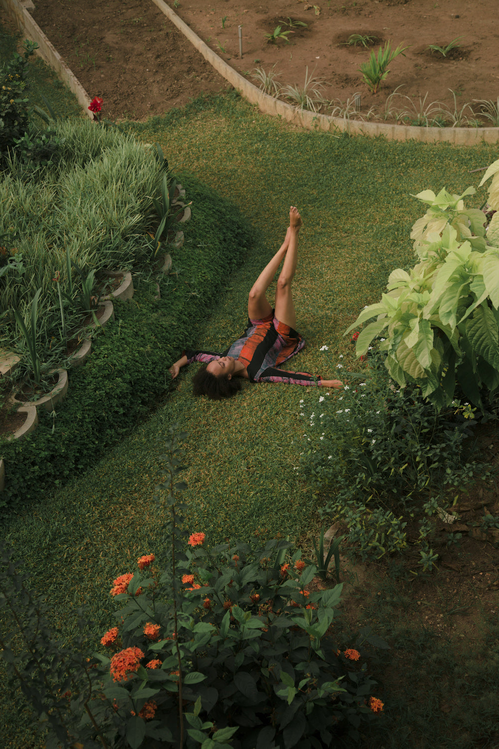 Efua Sutherland laying in the grass