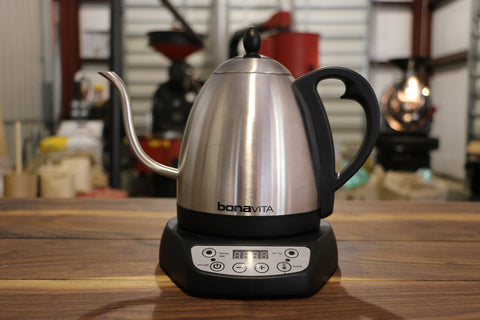 An electric tea kettle heating up on a counter. 