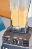 A blender mixes up an eggnog drink on a countertop. 