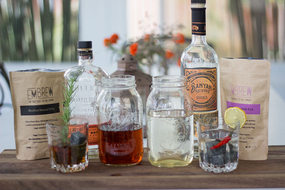 A table of four tea-inspired cocktails using Embrew's Lavendar Chamomile Kick and Bourbon Smoked White blends. 