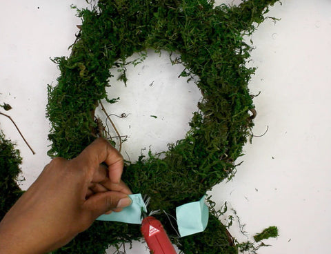 hot glue ribbon bow to DIY easter bunny wreath