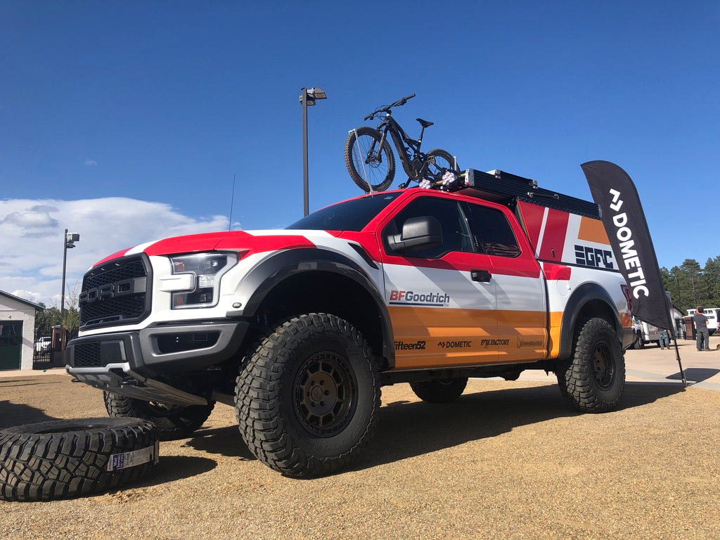 Front/side view of red and white Ford truck