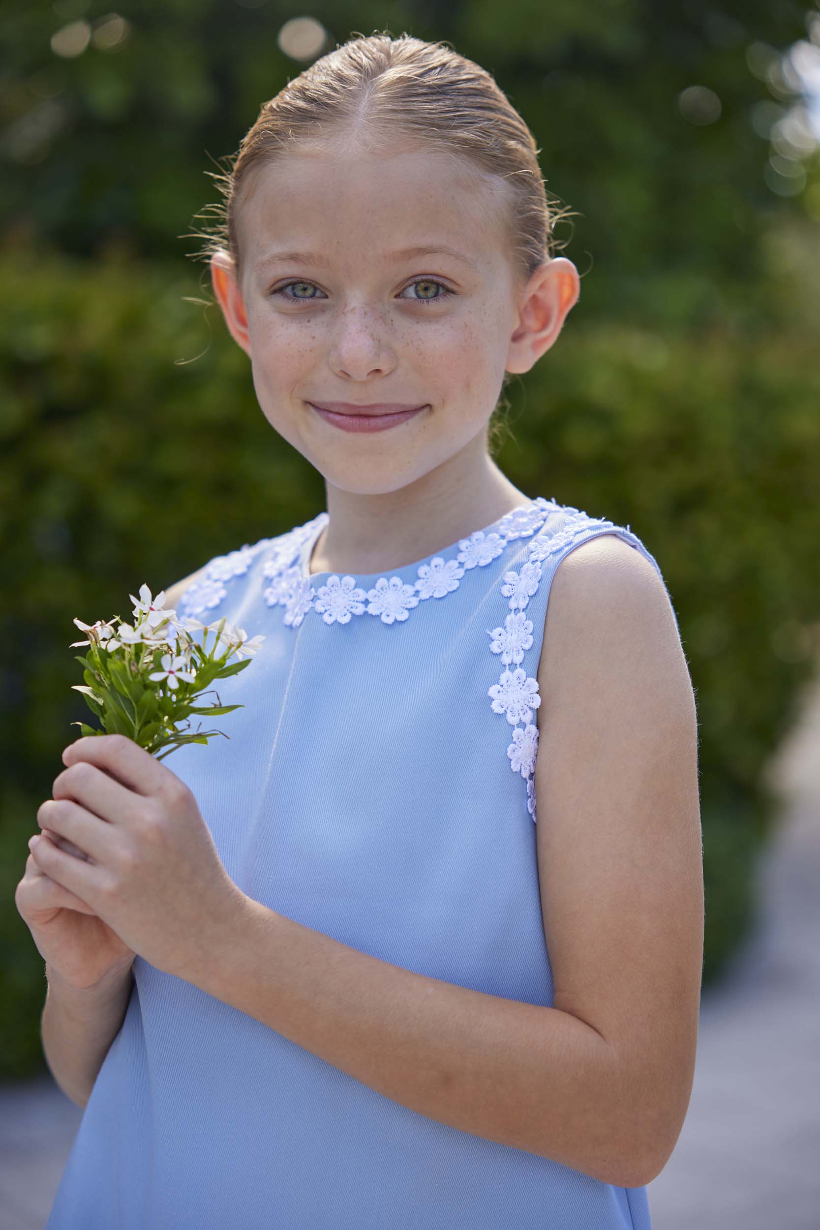 classic childrens clothing girls blue twill shift dress with daisy pattern around hem and arms