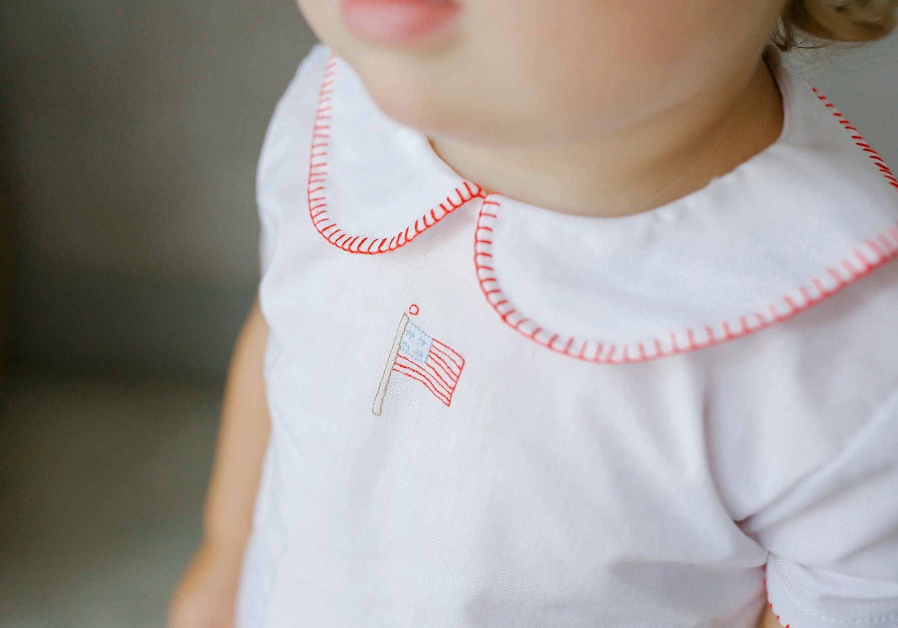 seguridadindustrialcr woven top with red whipstitch and an embroidered flag at the chest