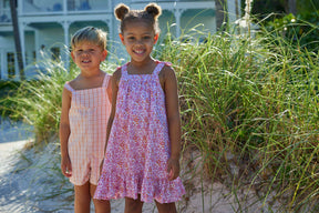 classic childrens clothing girls strapless dress in pink and orange floral print with bows on the sleeve straps