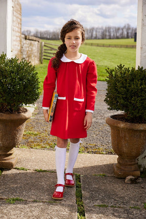 classic childrens clothing girls long sleeve dress with white peter pan collar and front pocket details