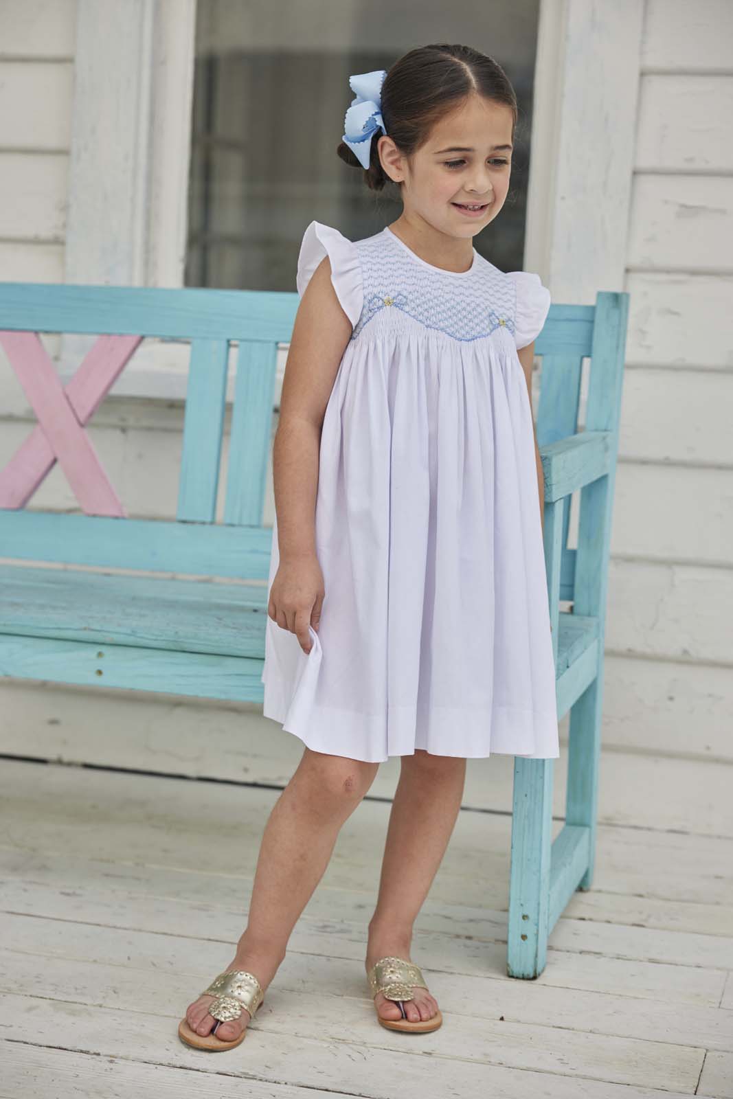 classic childrens clothing girls white dress with ruffle sleeves and blue smocking