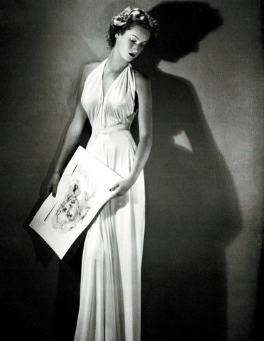 From the book, The Last Swan, Marella Caracciolo di Castagneto, wearing a gown by Gabriella Sport and holding a watercolor by Leonor Fini, circa 1952-53.