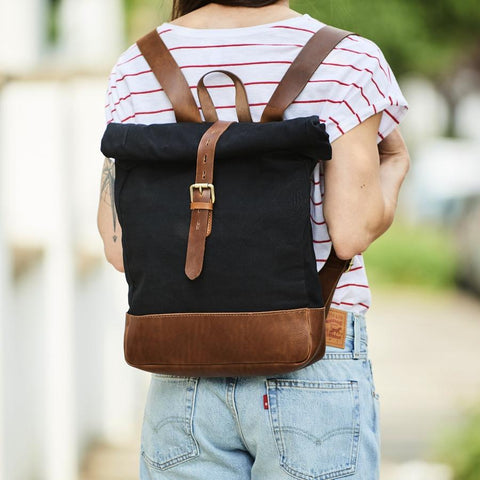Black canvas and brown leather roll-top backpack