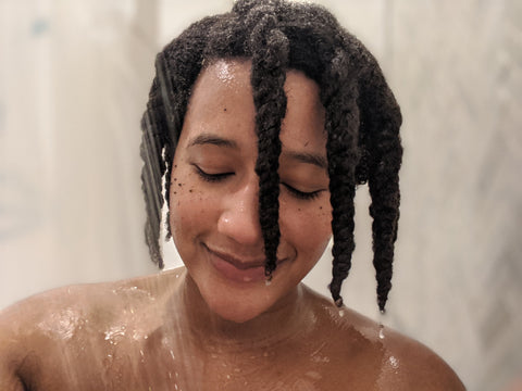 Kim Lewis CEO and CoFounder of CurlMix hair in the shower