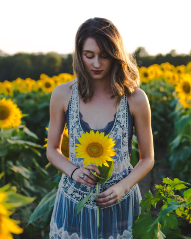Girl Holding Sunflower in sunflower field