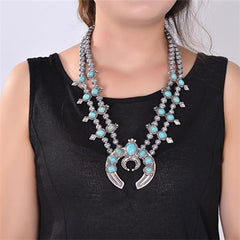 https://westcoastcg.com/products/shadow-of-moonlight-squash-blossom-necklace