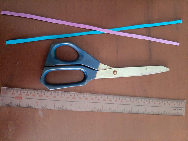 2 strips of thin paper (0.5cm in width), a pair of scissors, and ruler for measurement