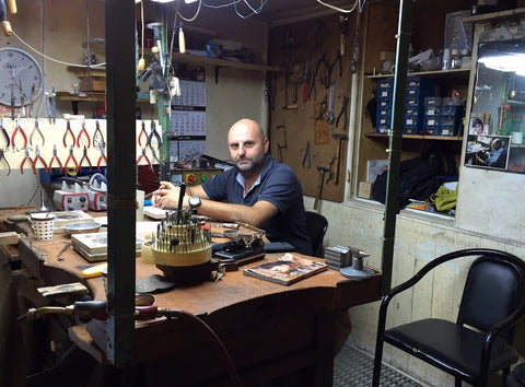master silversmith Eren Ozler sitting at his workshop desk in Imam Ali Han, the Grand Bazaar, Istanbul, Turkey