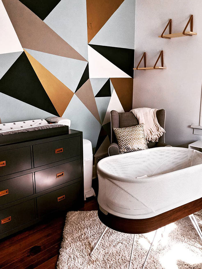 baby nursery with geometric pattern wallpaper and SNOO bassinet