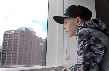 Boy looking out a window
