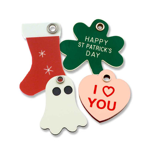 Red holiday stocking tag, green shamrock tag, glowing ghost tag, and pink "I Heart You" heart shaped tag