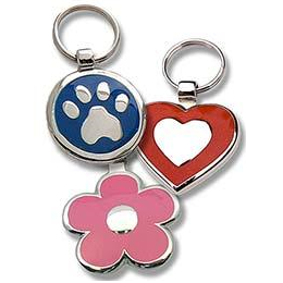 Round metal tag with blue enamel on front surrounding a metal paw design, heart shaped metal tag with red enamel on front surrounding a metal heart design, and daisy shaped metal tag with pink enamel on front